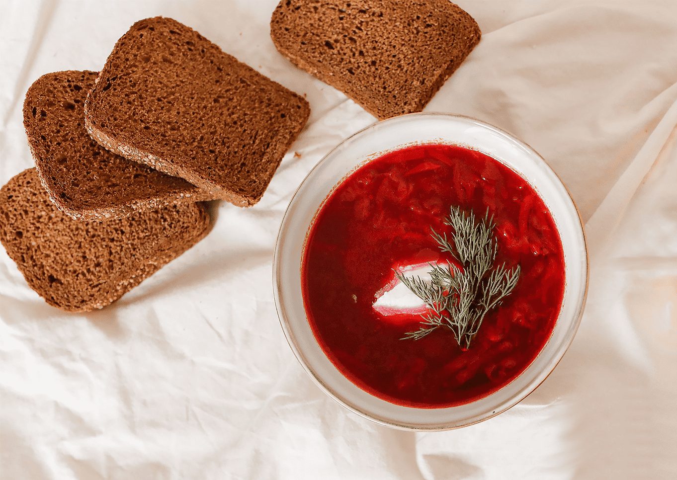 Bowl of beetroot soup with bread